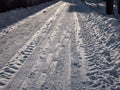 Road covered with compressed snow after heavy snowfall. Accumulation of snow on driving surface in winter. Slippery road