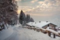 Road covered with snow with houses with sunrise Royalty Free Stock Photo