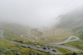 The road that crosses the Fagaras mountains seen from above among the fog, Transfagarasan, Romania Royalty Free Stock Photo