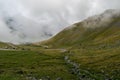 The road that crosses the Fagaras mountains seen from above among the fog, Transfagarasan, Romania Royalty Free Stock Photo