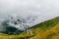 The road that crosses the Fagaras mountains seen from above among the fog, Transfagarasan, Romania Royalty Free Stock Photo