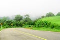 The road curves downhill with green nature park Royalty Free Stock Photo