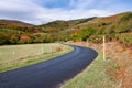 Road curves towards mountains in autumn colors in the French Pyrenees