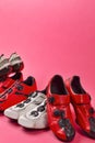 Road Cycling Concepts. Four Pairs of Carbon Red and White Professional Cycling Shoes Placed Together in Line Over Pink