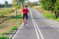 Road Cycling. One Emotional Male Cyclist Riding Road Bike Uphill Equipped with Summer Bike Outfit Posing Outdoor During Training Royalty Free Stock Photo