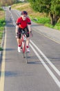 Road Cycling. One Emotional Male Cyclist Riding Road Bike Uphill Equipped with Summer Bike Outfit Posing Outdoor During Training Royalty Free Stock Photo