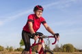 Road Cycling. One Emotional Male Cyclist Riding Road Bike Uphill Equipped with Summer Bike Outfit Posing Outdoor During Training Royalty Free Stock Photo