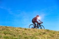 Road cyclist on a background of blue sky