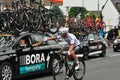 Road cyclist getting a drink from a support vehicle during Tour de France in Meerbusch, Germany