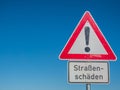 Road damage sign in german Royalty Free Stock Photo