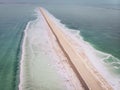 Road on Dead Sea surface. The southern part of the Dead Sea, is divided into pools from which extract minerals. shore is covered