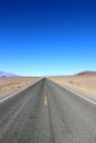 Road in the Death Valley National Park with colorful sky background, California