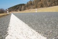 Road and detail of asphalt with reflector post