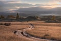 Road dirt mountains dawn trees hills clouds sky Royalty Free Stock Photo