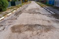 The road is in disrepair with potholes. Background with selective focus as copy space