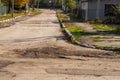 The road is in disrepair with potholes. Background with selective focus as copy space