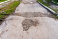 The road is in disrepair with potholes. Background with selective focus as copy space