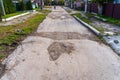 The road is in disrepair with potholes. Background with selective focus as copy space