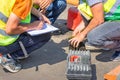 Road engineers measure the thickness of the laid asphalt and record the data in a spreadsheet
