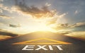 Road Exit sign leading to a hope and light in Golden cloud sunset sky, pathway to solution and freedom concept