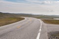 The road is far away against the background of stony hills Royalty Free Stock Photo