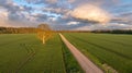 road through farmlands at sunset Royalty Free Stock Photo