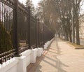 Road and fence flooded with sun Royalty Free Stock Photo