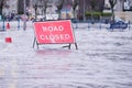 Road flood closed sign under deep water during bad extreme heavy rain storm weather in UK Royalty Free Stock Photo