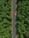 Aerial view of a car on the road in the forest . Royalty Free Stock Photo