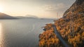 Road through forest along lake and mountains in Stora SjÃ¶fallet National Park in autumn in Lapland in Sweden from above Royalty Free Stock Photo