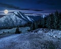 Road through forest to high mountains at night Royalty Free Stock Photo