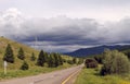 Road in forest under a blue sky with white clouds Sayan mountains Siberia Russia Royalty Free Stock Photo