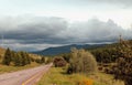 Road in forest under a blue sky with white clouds Sayan mountains Siberia Russia Royalty Free Stock Photo