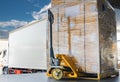 Road freight cargo shipment by truck. Large shipments pallet goods waiting for load into container shipping truck. Royalty Free Stock Photo