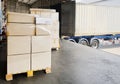 Road freight cargo transport by truck. Shipments boxes on pallet waiting for load into container shipping truck.