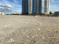 The road in front of a tall large beautiful modern new building of a glass and concrete skyscraper on a construction site of a big Royalty Free Stock Photo