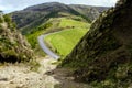 Road going through mountains and green hills