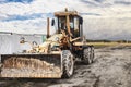 Road grader - heavy equipment for road construction and earthworks. Leveling and improvement of the ground surface. Construction Royalty Free Stock Photo