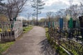 Road among the graves at the old Troitsk cemetery 1842 in the city of Krasnoyarsk, in the spring.