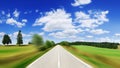 Road among green fields with motion blur effect