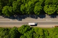 Road through the green forest, aerial view car drive going through forest, top down view forest, view from above Royalty Free Stock Photo