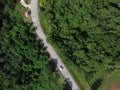 Road through green forest Aerial view of car passing through forest Royalty Free Stock Photo