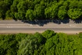 Road through the green forest, aerial view car drive going through forest, top down view forest, view from above Royalty Free Stock Photo