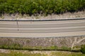 Road through the green forest, aerial view car drive going through forest, top down view forest, view from above Royalty Free Stock Photo