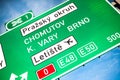 Road green traffic sign from D0 Prague Ring. Highway exit to cities Brno, Chomutov, Karlovy Vary and Vaclav Havel airport