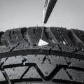 Road Hazard Puncturing a Car Tire Tread Royalty Free Stock Photo