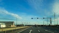 A road or highway leading to the horizon. View from the car window. Northern dim summer, blue sky with white clouds. Royalty Free Stock Photo