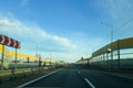 A road or highway leading to the horizon. View from the car window. Northern dim summer, blue sky with white clouds. Royalty Free Stock Photo