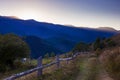 The road on hill and fence on mountain background