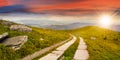 Road on a hillside near mountain peak at sunset Royalty Free Stock Photo